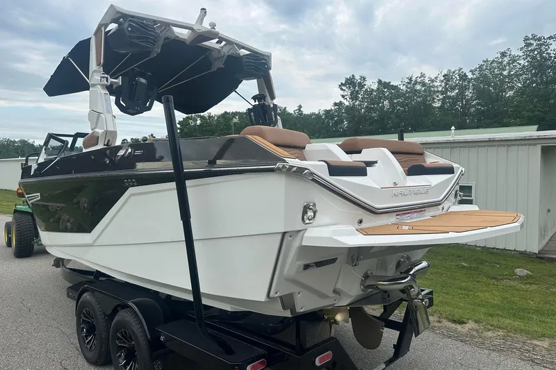 Slide: The Image of 2025 Nautique Super Air Nautique G23 boat on trailer, rear view, parked outdoors. - 4