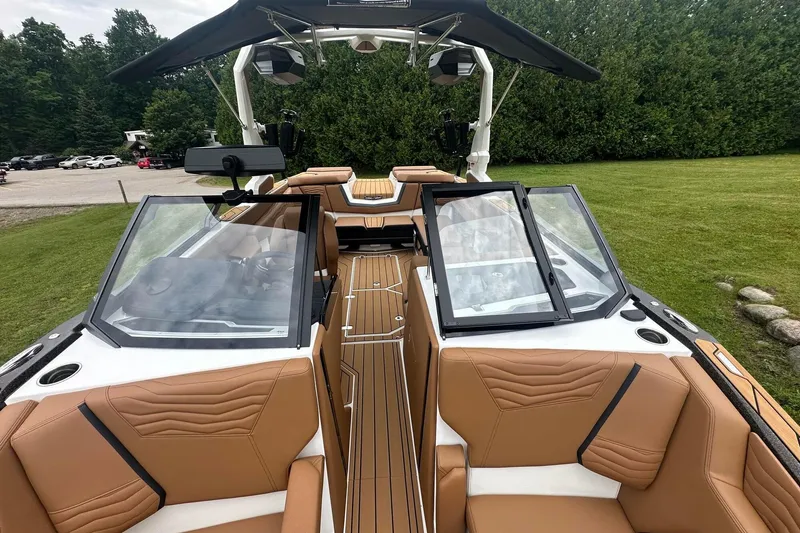 Slide: The Image of 2025 Nautique Super Air Nautique G23 boat with tan seating and sleek design. - 42