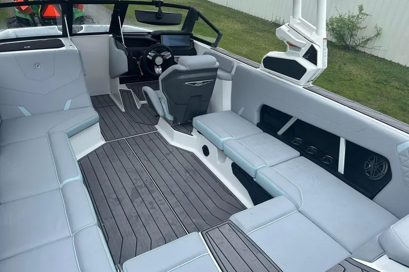 Slide: The Image of 2025 Nautique Super Air Nautique GS22 interior with sleek seating and modern dashboard design. - 12