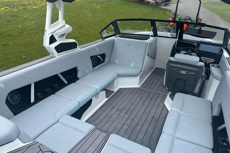 Slide: The Image of 2025 Nautique Super Air Nautique GS22 interior with sleek seating and modern dashboard. - 13