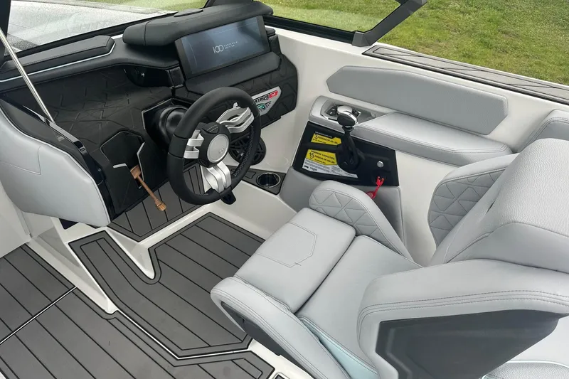 Slide: The Image of 2025 Nautique Super Air Nautique GS22 cockpit with modern steering and controls. - 15