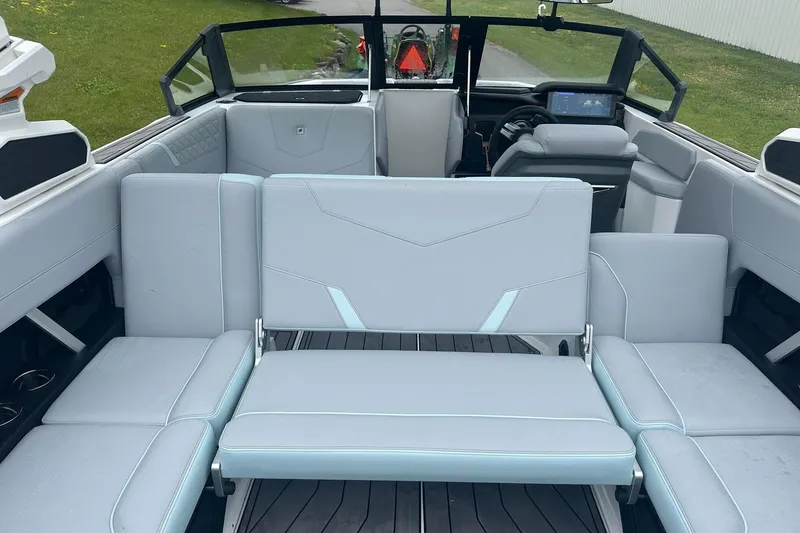 Slide: The Image of 2025 Nautique Super Air Nautique GS22 interior with modern seating and dashboard. - 21
