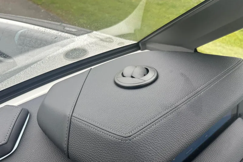 Slide: The Image of 2025 Nautique Super Air Nautique GS22 dashboard with sleek black leather finish. - 22