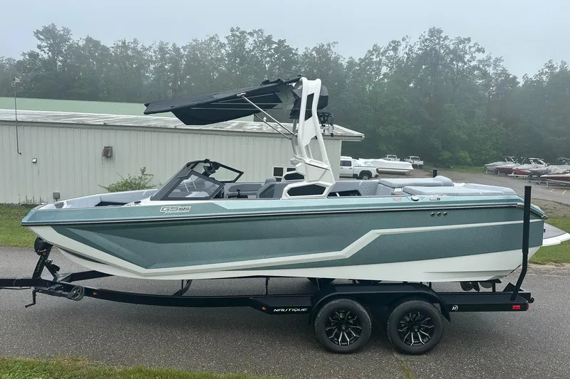 Slide: The Image of 2025 Nautique Super Air Nautique GS22 boat on trailer, parked outdoors. - 3