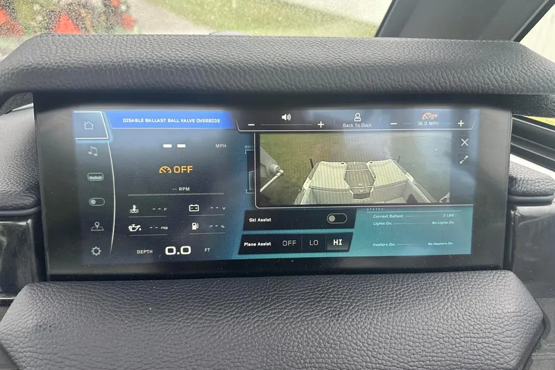 Slide: The Image of 2025 Nautique Super Air Nautique GS22 dashboard display with control settings and rear camera view. - 30