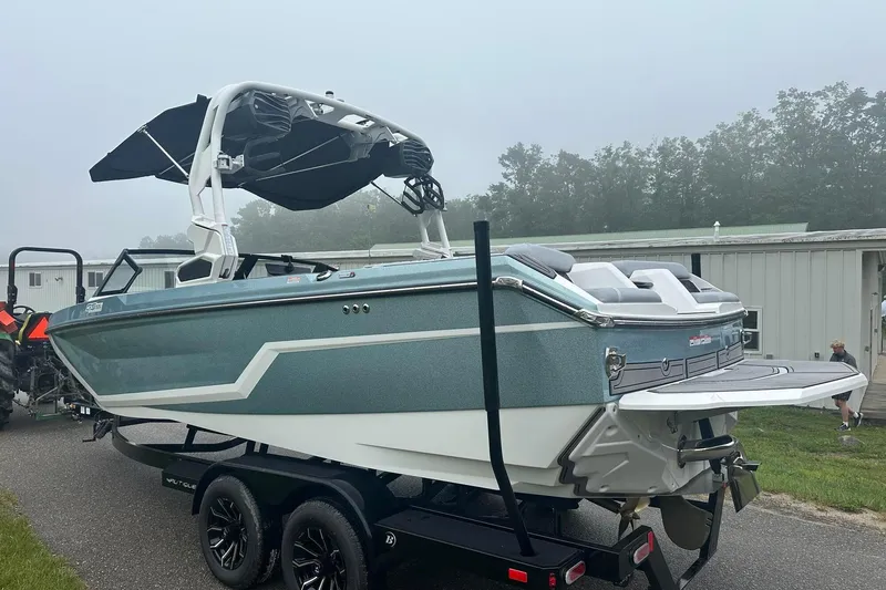 Slide: The Image of 2025 Nautique Super Air Nautique GS22 boat on trailer, sleek design, overcast day. - 4