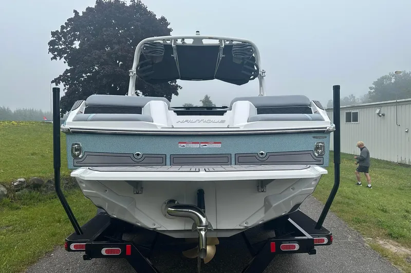 Slide: The Image of 2025 Nautique Super Air Nautique GS22 boat on trailer, rear view, outdoors. - 5