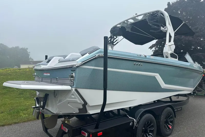 Slide: The Image of 2025 Nautique Super Air Nautique GS22 boat on trailer, misty background. - 6
