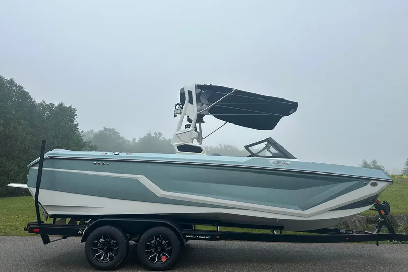 Slide: The Image of 2025 Nautique Super Air Nautique GS22 boat on trailer, misty background. - 7
