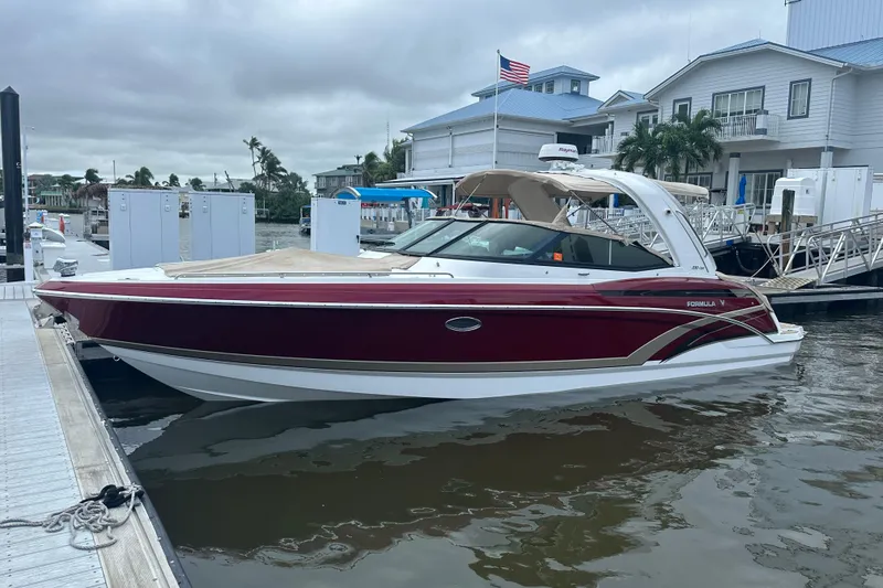 The Image of 2016 Formula 330 Crossover Bowrider docked at marina, overcast sky. - 0