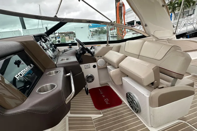 Slide: The Image of 2016 Formula 330 Crossover Bowrider interior with beige seating and modern dashboard. - 10