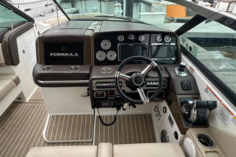 Slide: The Image of 2016 Formula 330 Crossover Bowrider dashboard with steering wheel and navigation controls. - 11