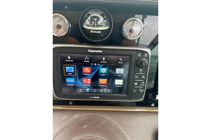 Slide: The Image of Raymarine navigation system on 2016 Formula 330 Crossover Bowrider dashboard with compass and gauges. - 12