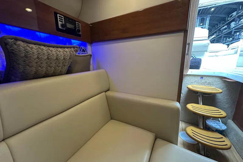 Slide: The Image of Interior of 2016 Formula 330 Crossover Bowrider with beige seating and wooden accents. - 14