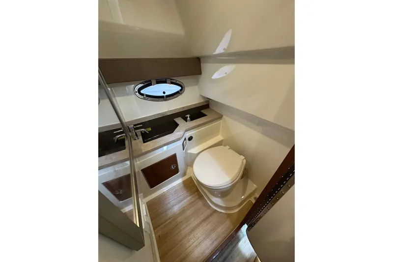 Slide: The Image of 2016 Formula 330 Crossover Bowrider bathroom with modern fixtures and wood flooring. - 15