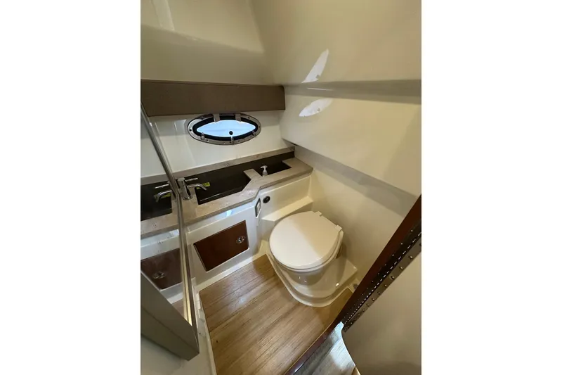 Slide: The Image of Interior of 2016 Formula 330 Crossover Bowrider bathroom with modern fixtures and wood flooring. - 16