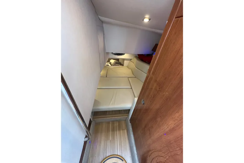 Slide: The Image of 2016 Formula 330 Crossover Bowrider cabin interior with cozy seating and wooden accents. - 17