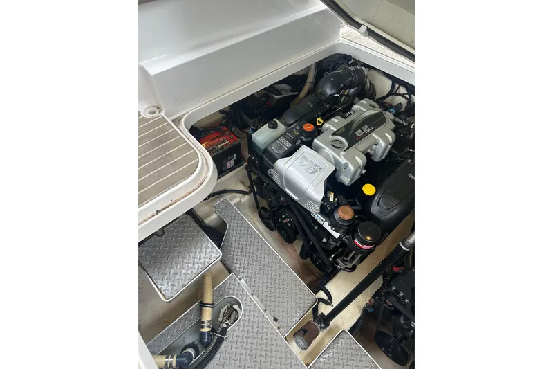 Slide: The Image of Engine compartment of a 2016 Formula 330 Crossover Bowrider, showcasing powerful motor components. - 19