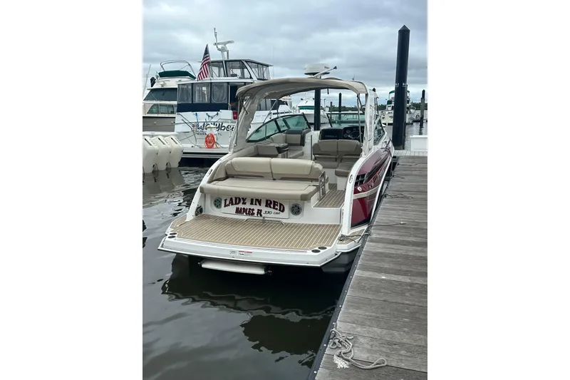 Slide: The Image of 2016 Formula 330 Crossover Bowrider docked, featuring spacious seating and elegant design. - 3