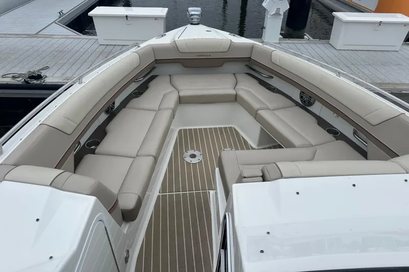 Slide: The Image of 2016 Formula 330 Crossover Bowrider with spacious seating at dockside. - 4