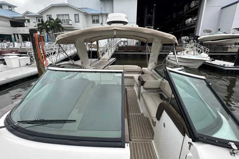 Slide: The Image of 2016 Formula 330 Crossover Bowrider docked at marina, showcasing spacious seating and sleek design. - 5