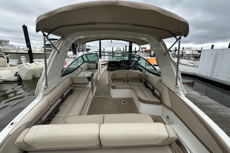 Slide: The Image of 2016 Formula 330 Crossover Bowrider with spacious seating and canopy at marina. - 7