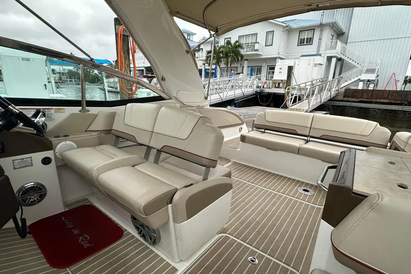 Slide: The Image of 2016 Formula 330 Crossover Bowrider interior with beige seating and wood-style flooring. - 8