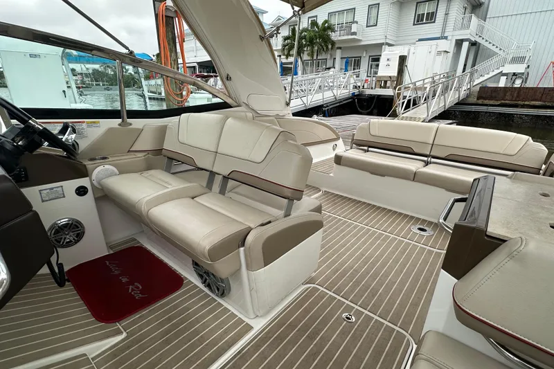 Slide: The Image of 2016 Formula 330 Crossover Bowrider interior with beige seating and wood-style flooring. - 9