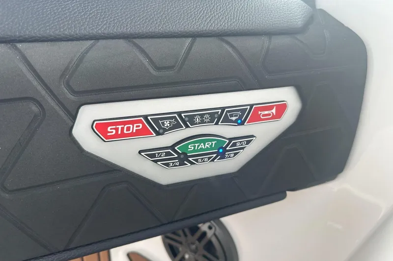 Slide: The Image of Control panel of 2025 Nautique Super Air Nautique GS22 boat with start and stop buttons. - 10