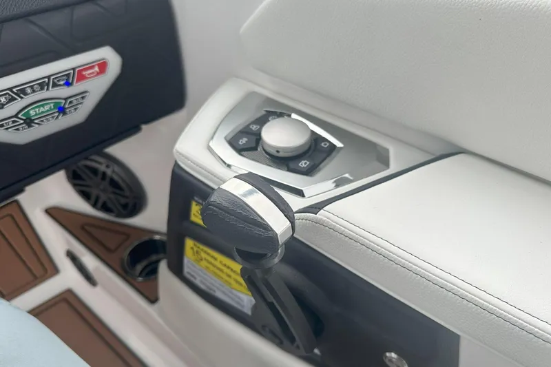 Slide: The Image of 2025 Nautique Super Air Nautique GS22 control panel with start button and throttle lever. - 11