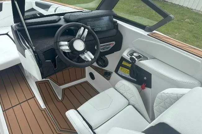 Slide: The Image of 2025 Nautique Super Air Nautique GS22 interior with sleek steering wheel and modern dashboard. - 13