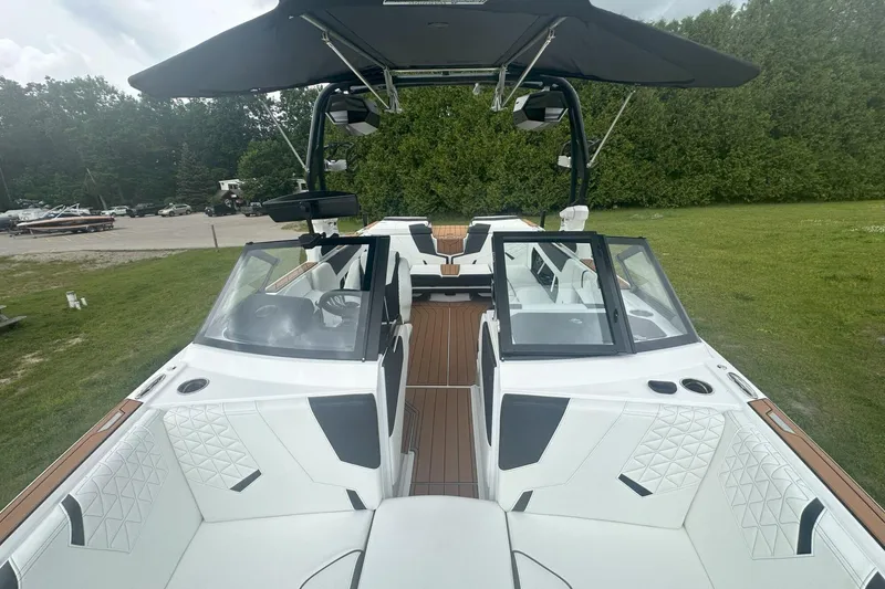 Slide: The Image of 2025 Nautique Super Air Nautique GS22 boat with sleek interior and canopy. - 15