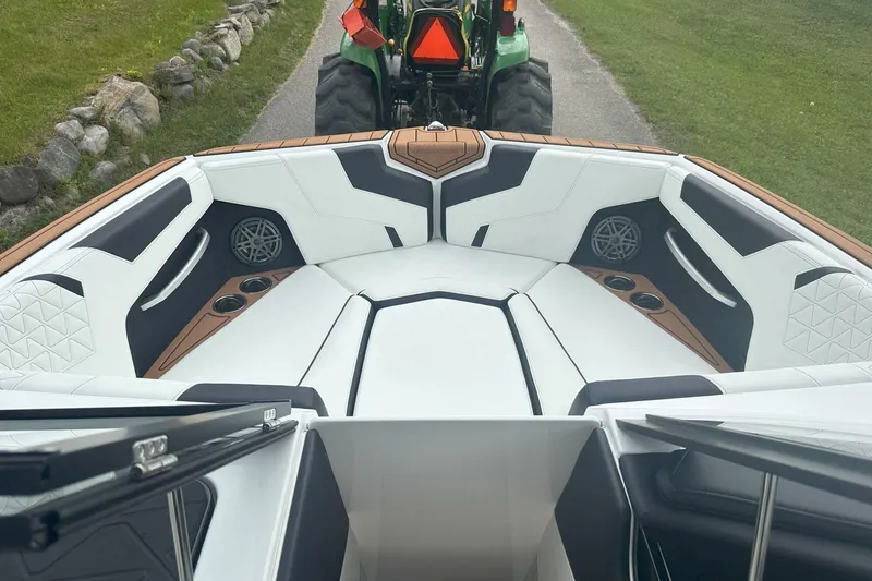 Slide: The Image of 2025 Nautique Super Air Nautique GS22 interior with white seating and cup holders. - 18