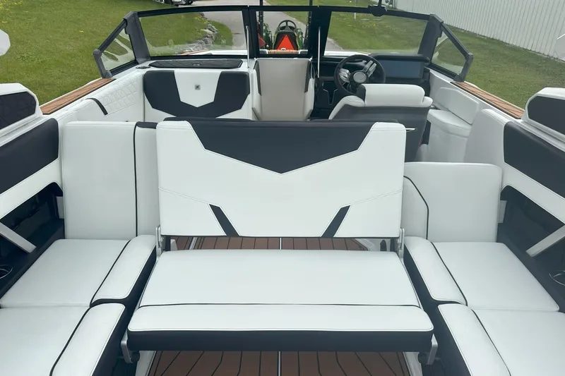 Slide: The Image of 2025 Nautique Super Air Nautique GS22 interior with sleek black and white seating design. - 19