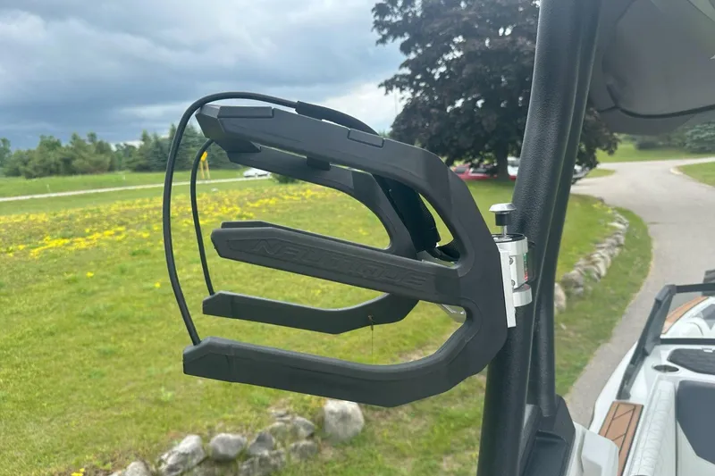 Slide: The Image of 2025 Nautique Super Air Nautique GS22 wakeboard rack on a boat, with scenic background. - 22