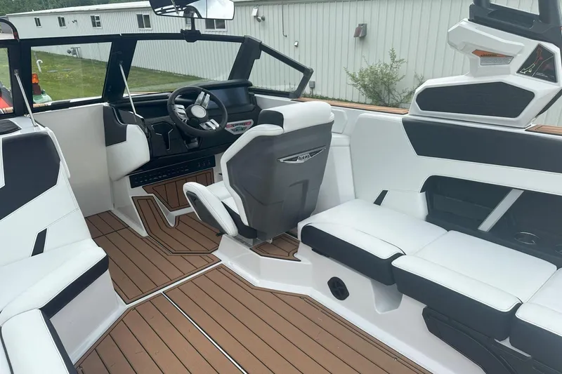 Slide: The Image of 2025 Nautique Super Air Nautique GS22 interior with sleek seating and modern dashboard design. - 23