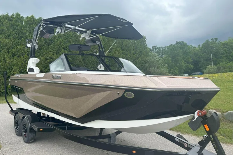 Slide: The Image of 2025 Nautique Super Air Nautique GS22 boat on trailer, parked outdoors. - 4