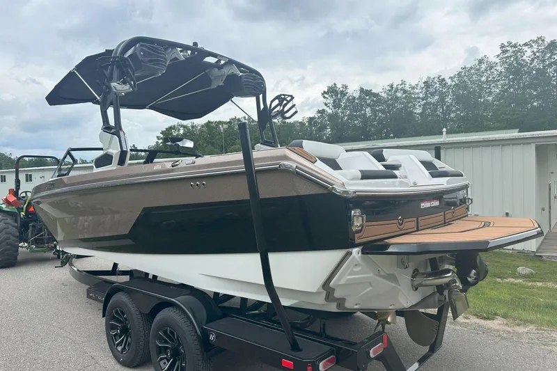 Slide: The Image of 2025 Nautique Super Air Nautique GS22 boat on trailer, featuring sleek design and modern amenities. - 7