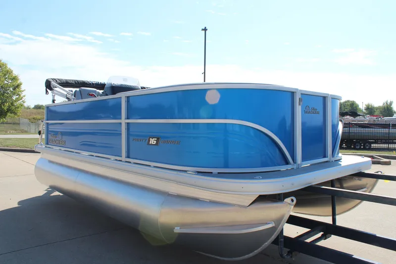 Slide: The Image of 2026 Sun Tracker Party Barge 16 DLX pontoon boat in bright blue on trailer. - 5