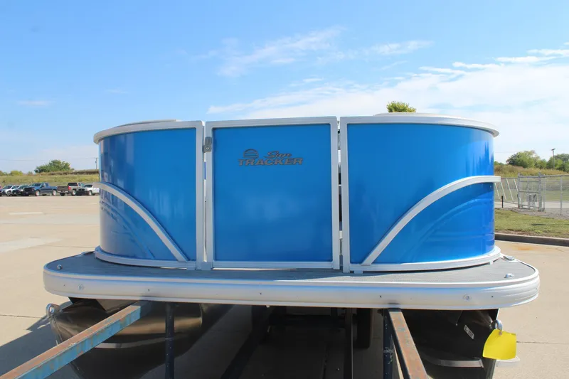 Slide: The Image of 2026 Sun Tracker Party Barge 16 DLX pontoon boat with blue exterior on a trailer. - 6