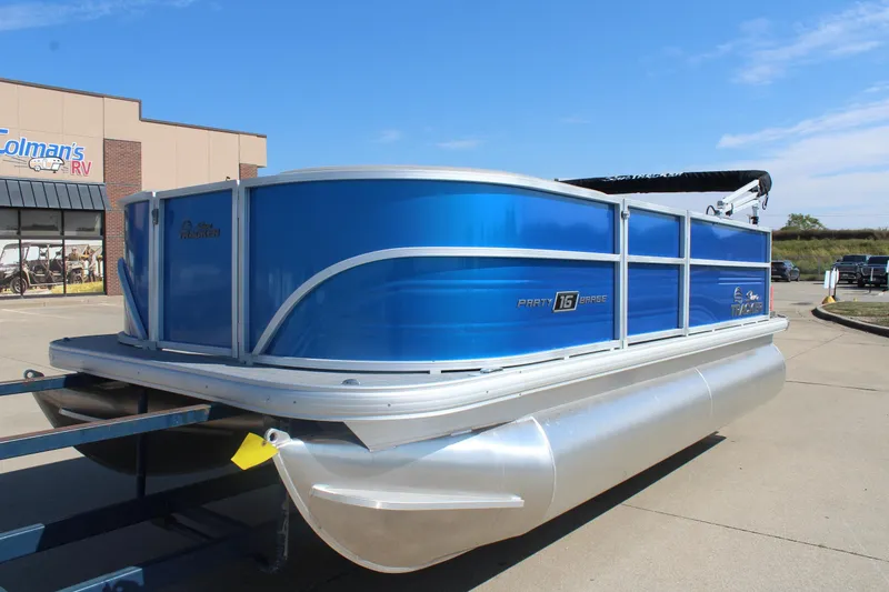 Slide: The Image of 2026 Sun Tracker Party Barge 16 DLX pontoon boat in a parking lot. - 7
