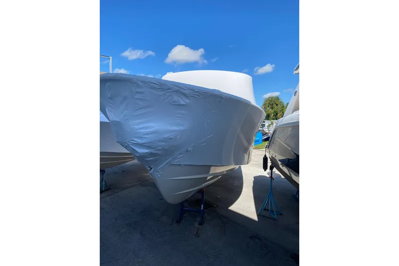 The Image of 2026 Grady-White Freedom 307 boat wrapped in protective cover, parked outdoors. - 0