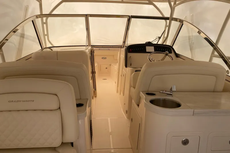 Slide: The Image of 2026 Grady-White Freedom 307 boat interior with helm, seating, and sink. - 10