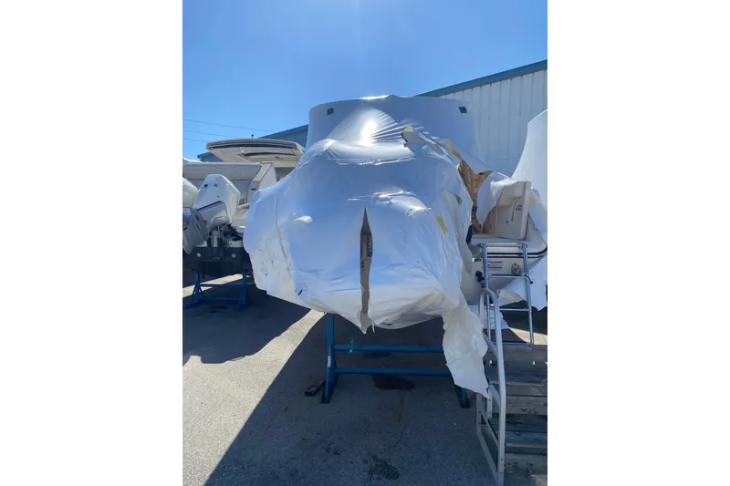 Slide: The Image of 2026 Grady-White Freedom 307 boat wrapped in protective covering outdoors. - 16