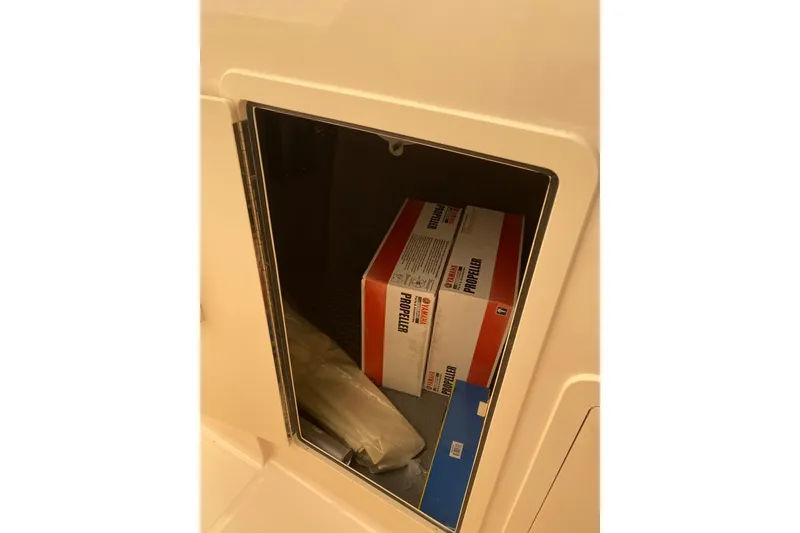 Slide: The Image of Storage compartment on 2026 Grady-White Freedom 307 boat with Yamaha propeller boxes. - 6