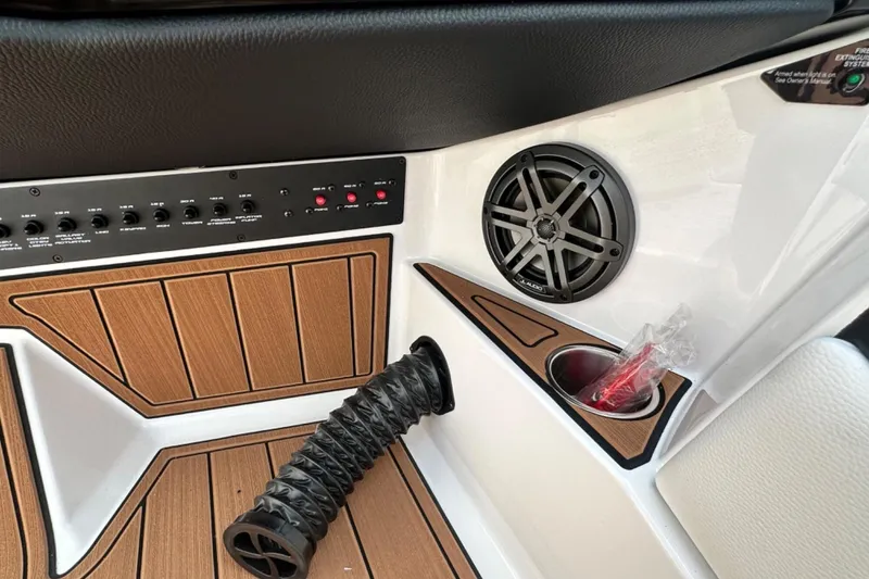 Slide: The Image of 2026 Nautique Super Air Nautique GS22E interior with speaker, control panel, and cup holder. - 10