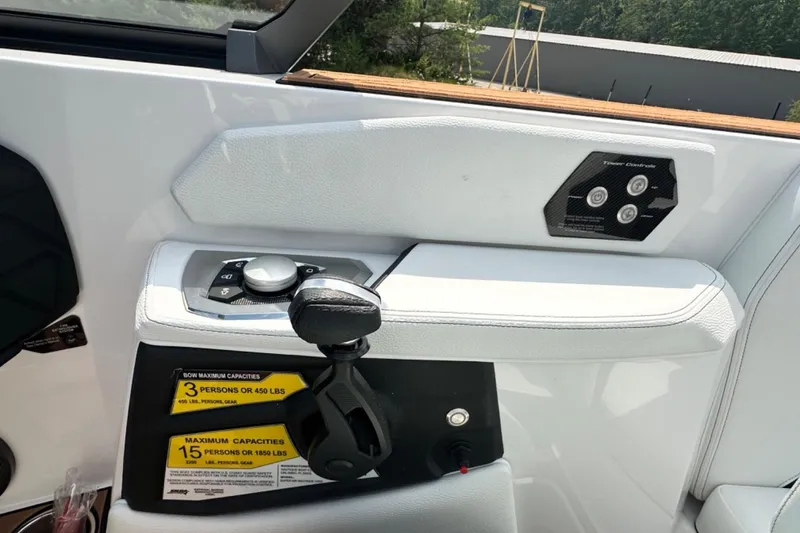 Slide: The Image of 2026 Nautique Super Air Nautique GS22E boat interior controls and capacity labels. - 12