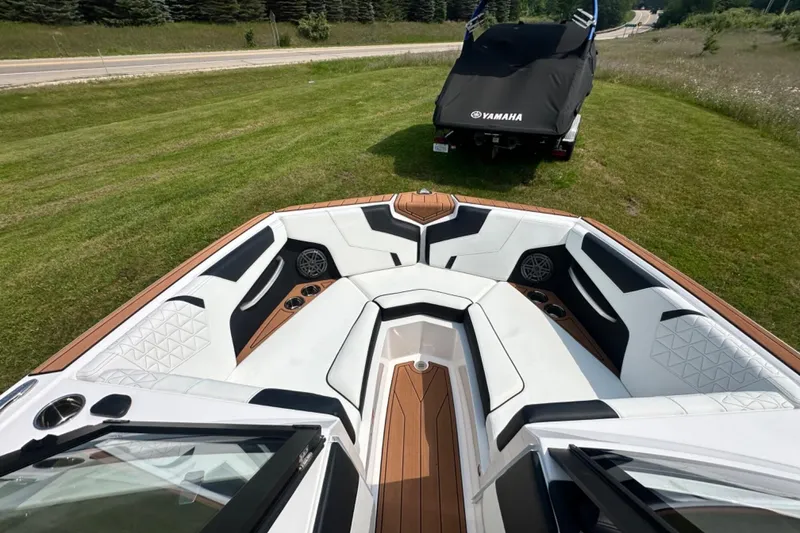 Slide: The Image of 2026 Nautique Super Air Nautique GS22E boat interior with luxurious seating and modern design. - 16