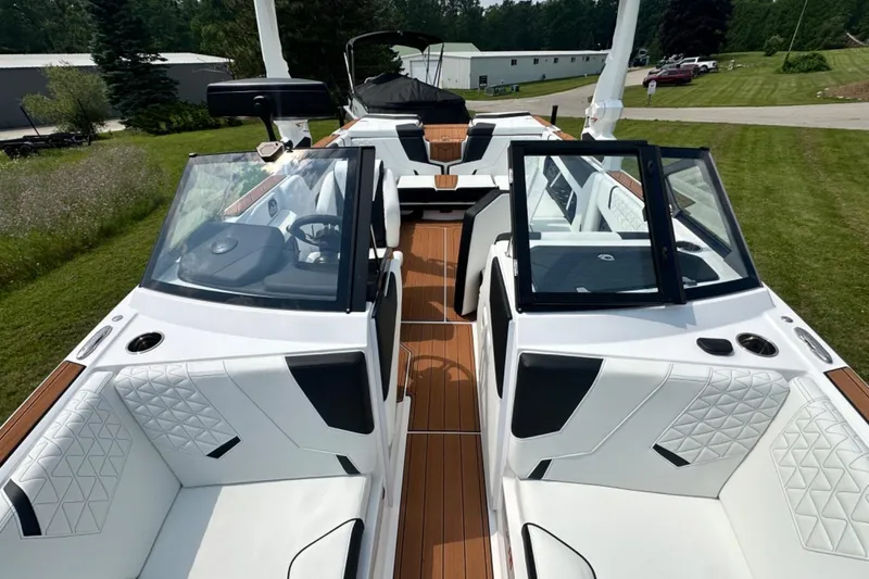 Slide: The Image of 2026 Nautique Super Air Nautique GS22E boat interior with white seating and sleek design. - 18