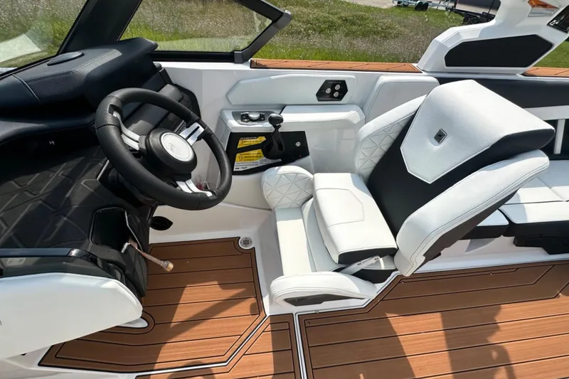 Slide: The Image of 2026 Nautique Super Air Nautique GS22E cockpit with luxury seating and modern steering wheel. - 20